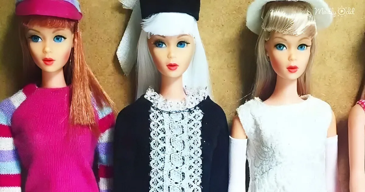 Three vintage dolls in colorful outfits stand side by side against a corkboard background.