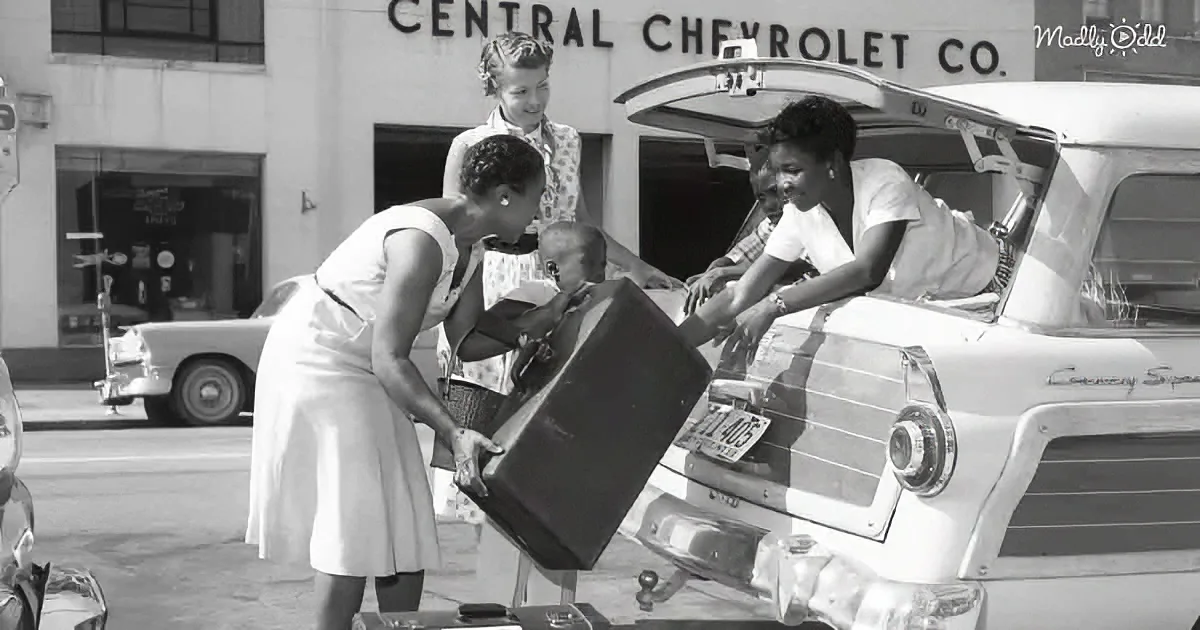 Women load luggage into a vintage car outside Central Chevrolet Co.