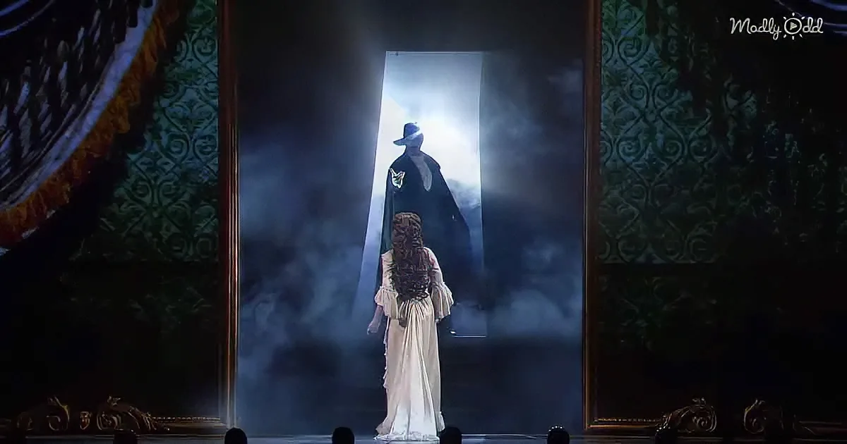 A figure in a white dress stands before a dark, illuminated doorway, creating a dramatic contrast.