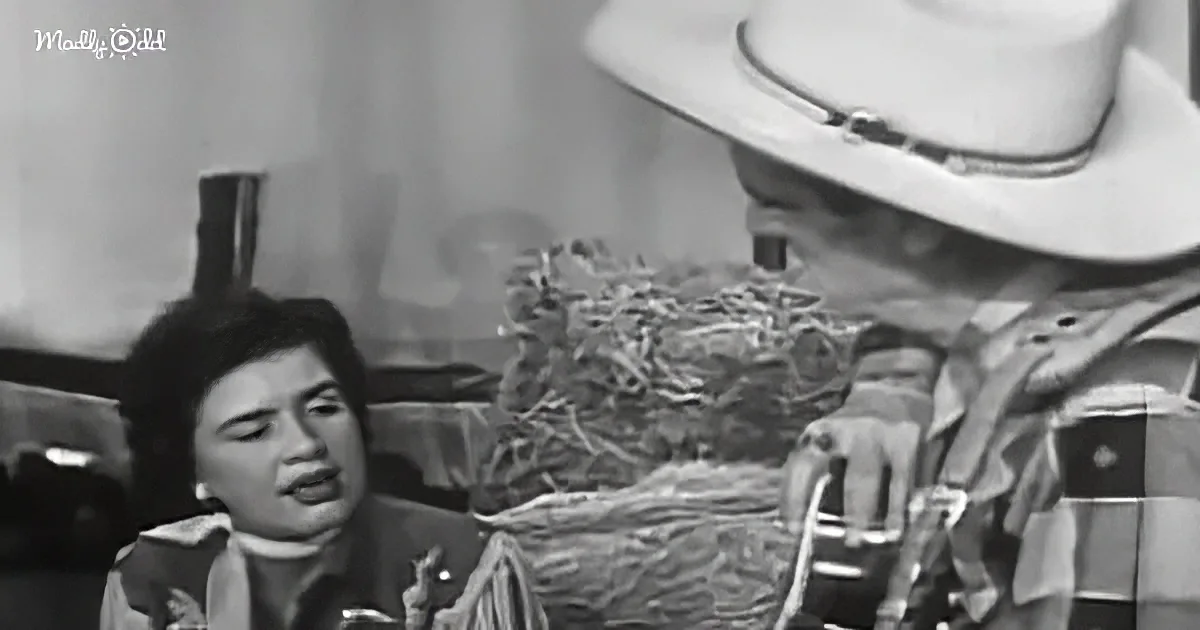 A cowboy in a white hat leans over a table, interacting with a person in a military-style uniform.