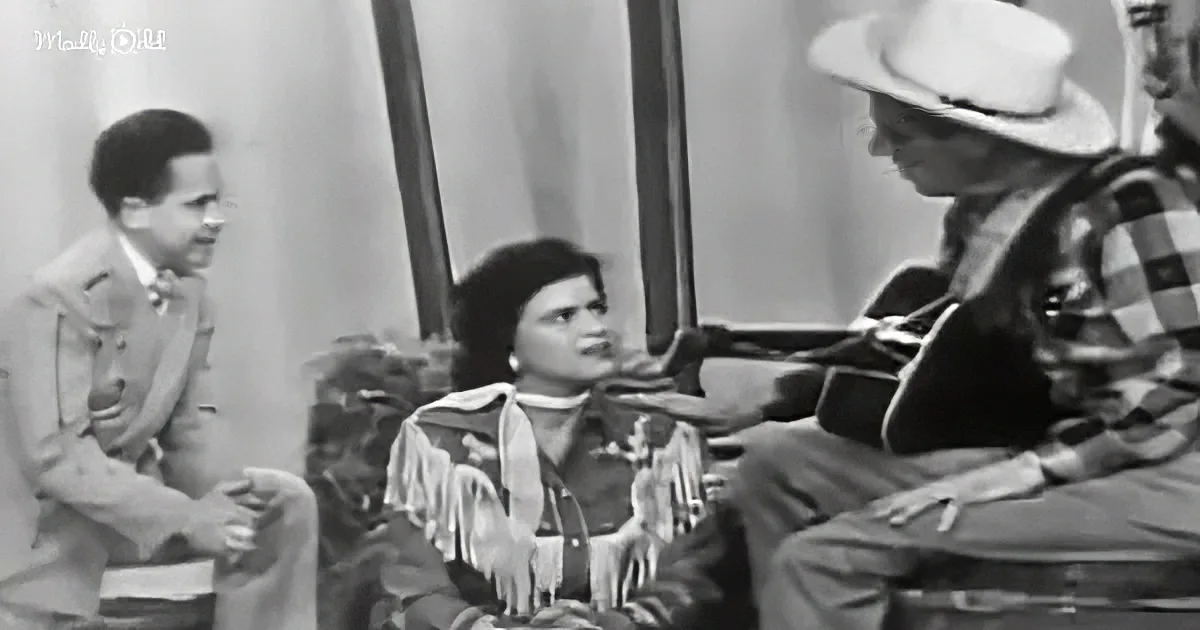 A woman in a Western-style outfit is seated, engaged in conversation with a man in a hat and plaid shirt, while another...