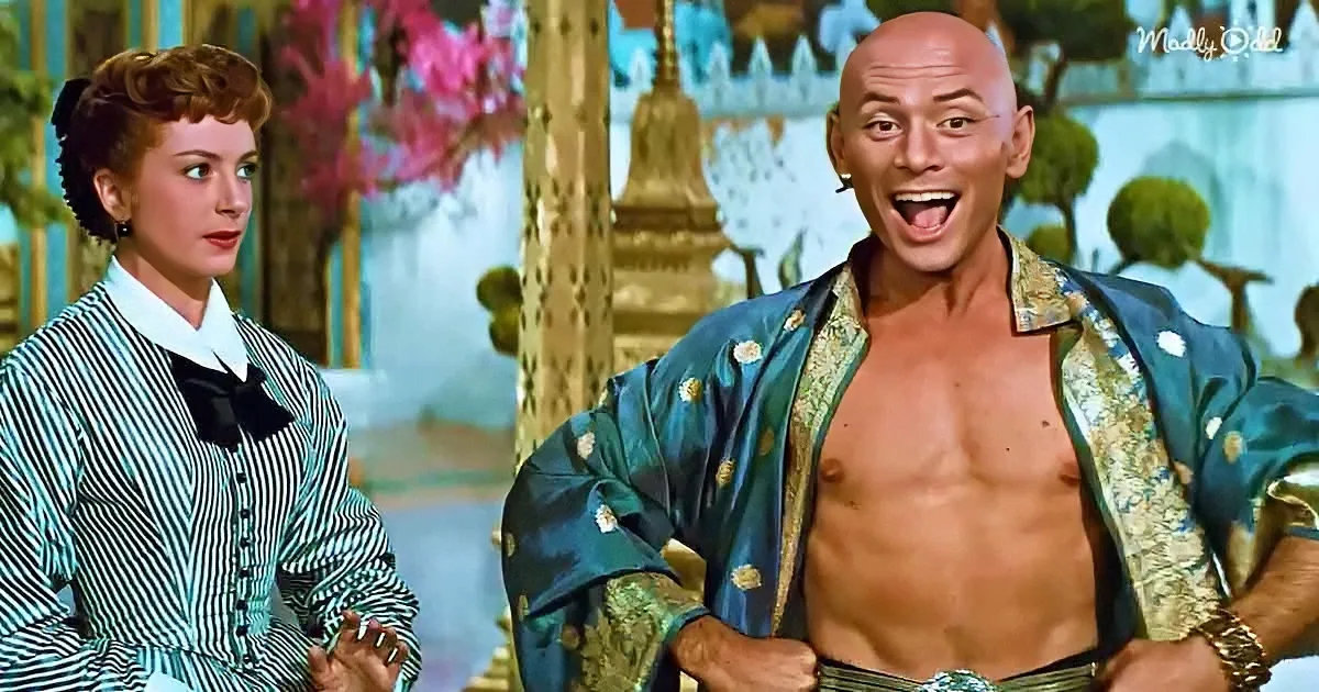 A man in a blue floral robe and a woman in a striped dress stand in a colorful, ornate setting.