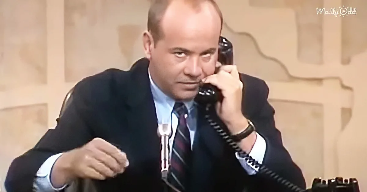 A man in a suit and tie is holding a telephone to his ear, appearing to be in a serious conversation.