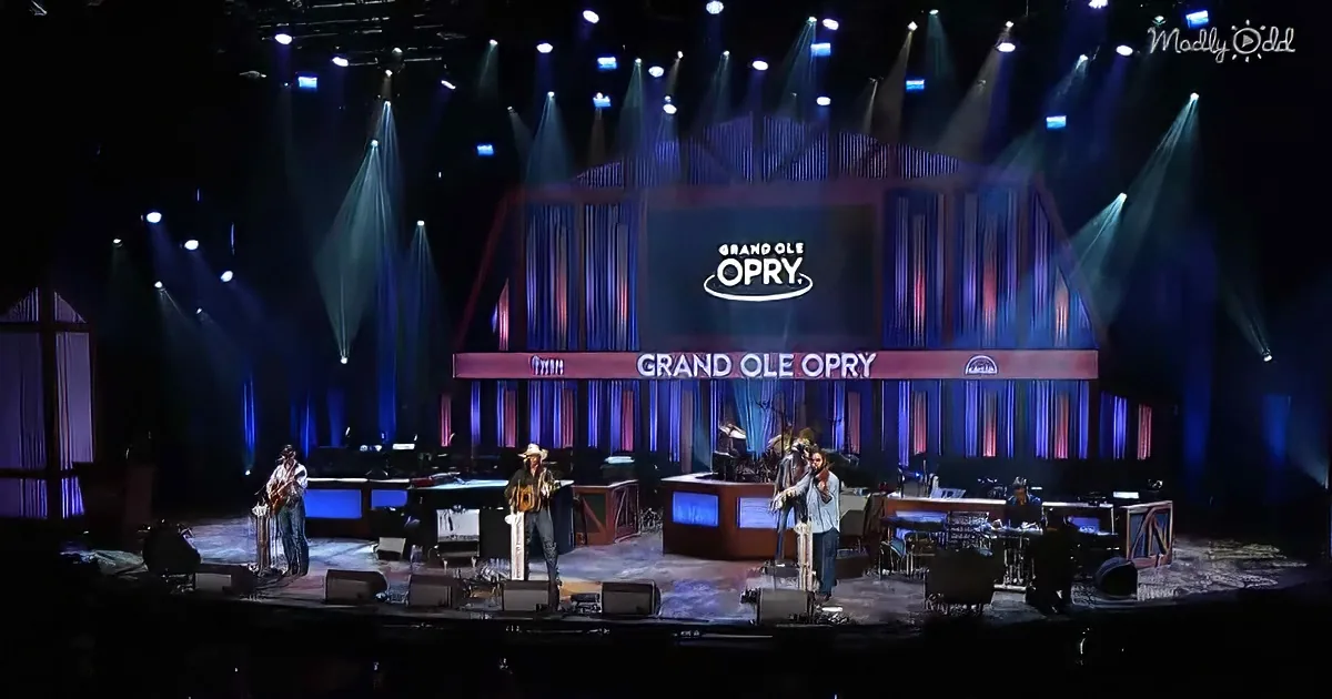 Musicians perform on a brightly lit stage at the Grand Ole Opry.