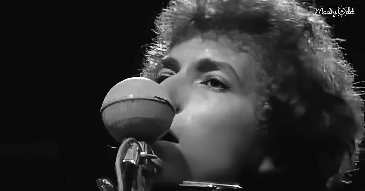 Bob Dylan singing into a microphone, close-up, black-and-white.