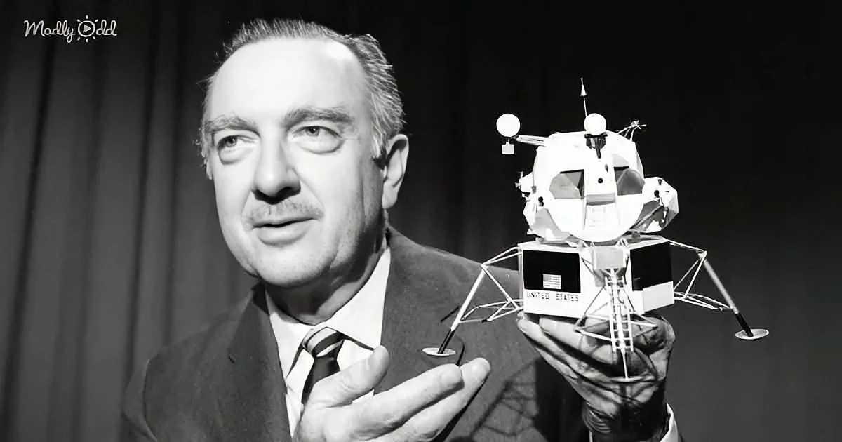 A man in a suit holds a model of a lunar lander, showcasing space exploration.