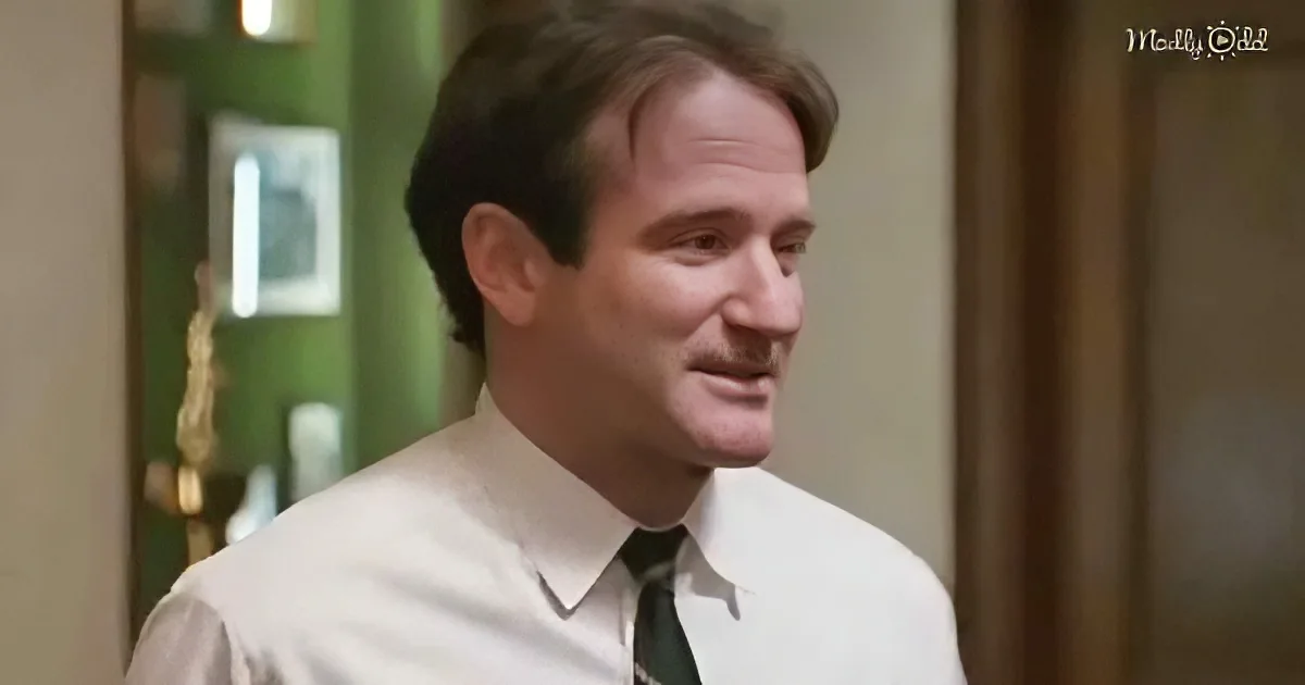 A man in a white shirt and tie smiles slightly, looking to the side, with a blurred background.
