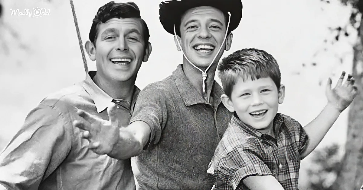 Three smiling individuals, two adults and a child, pose together in a black-and-white image.