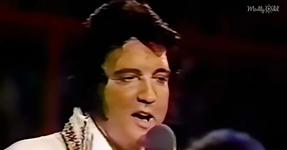 A close-up of a person singing into a microphone, wearing a white shirt with a patterned design.