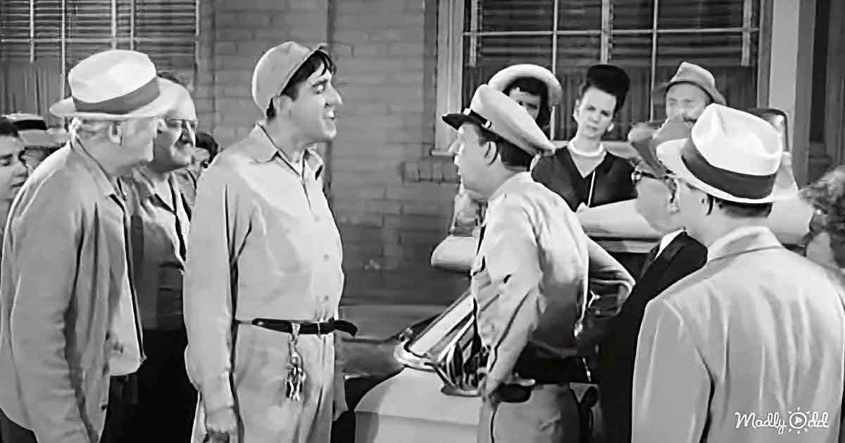 A man in a hat and shirt is speaking to a police officer in a crowd.