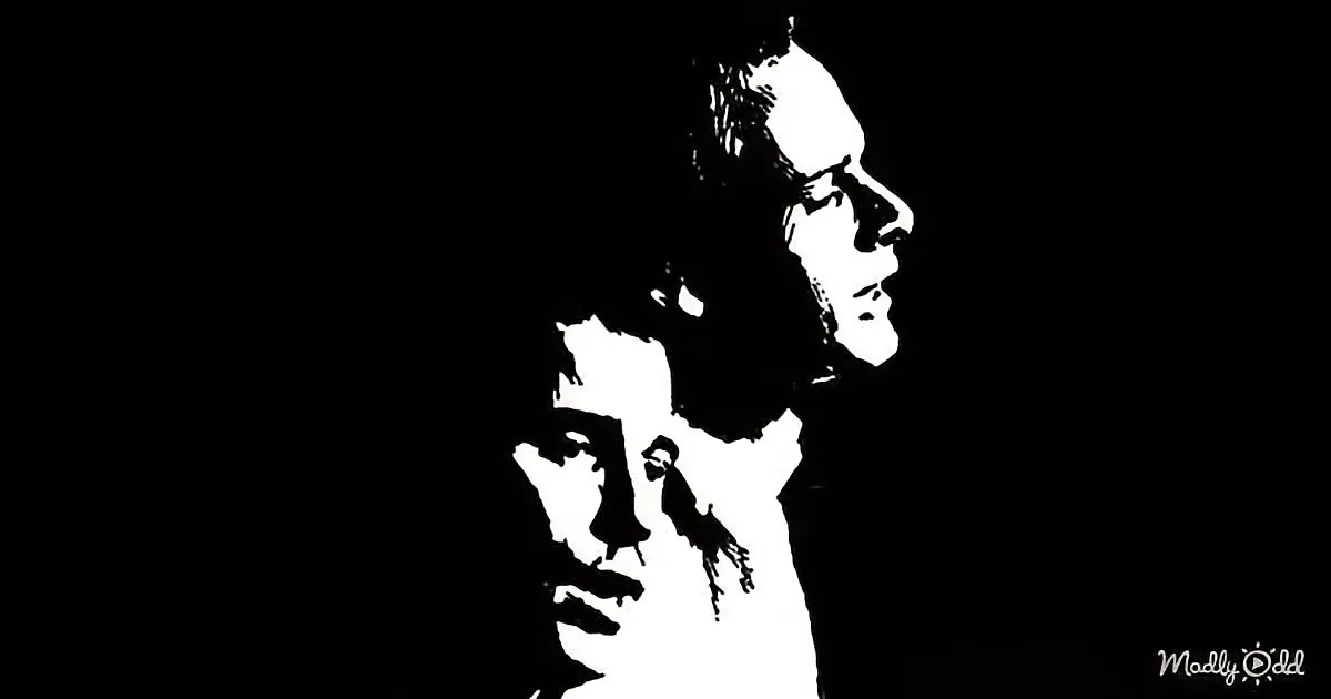 A black and white silhouette of a person with a bird perched on their shoulder, set against a dark background.