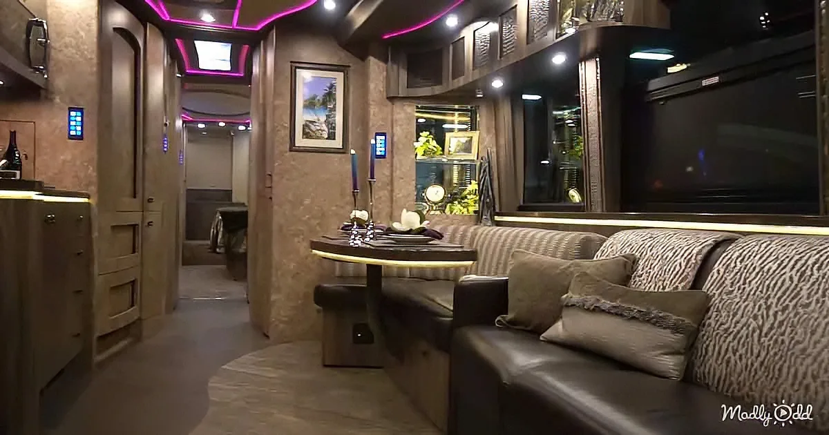 Luxurious RV interior with cozy seating, dining table, and decorative elements.