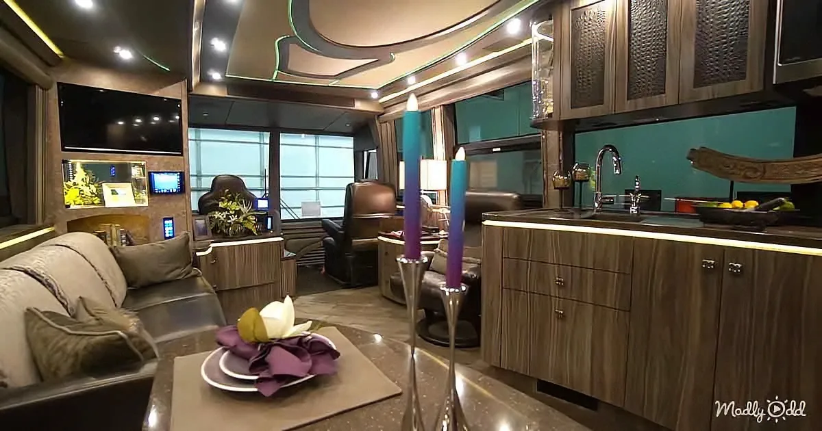 A luxurious RV interior with a modern kitchen, cozy seating, and decorative candles.