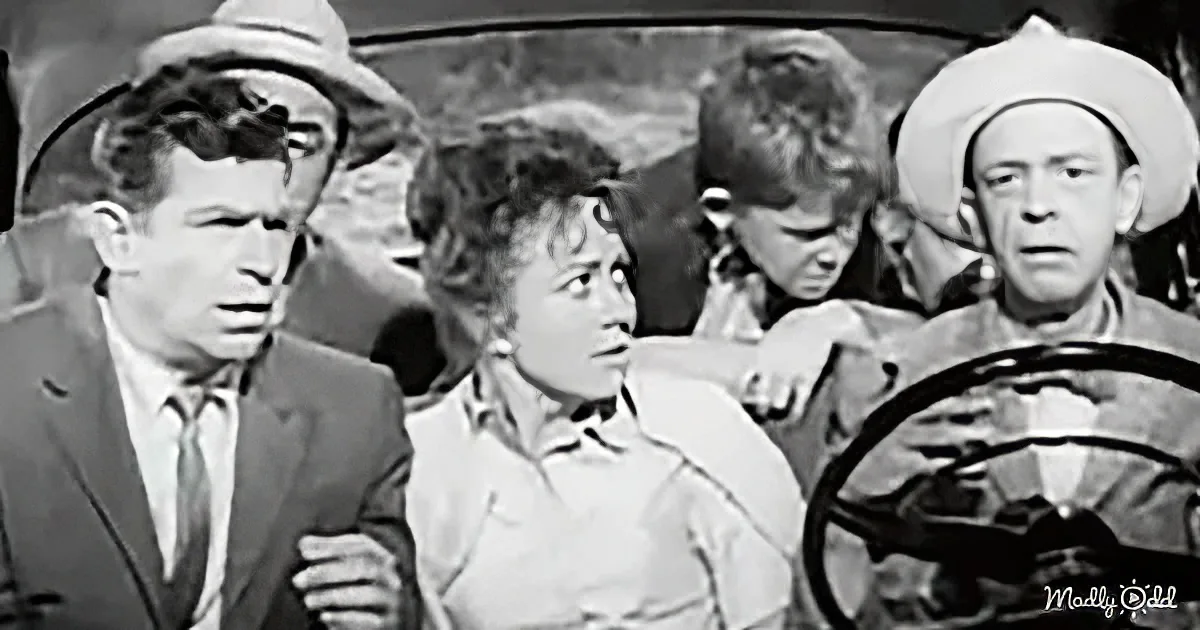 A man in a suit and hat is holding a woman's hand, while another man in a cowboy hat drives a car.