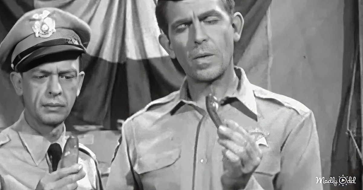 A man in a military uniform holds a cigarette, while another in a cap looks on, both in a black-and-white setting.