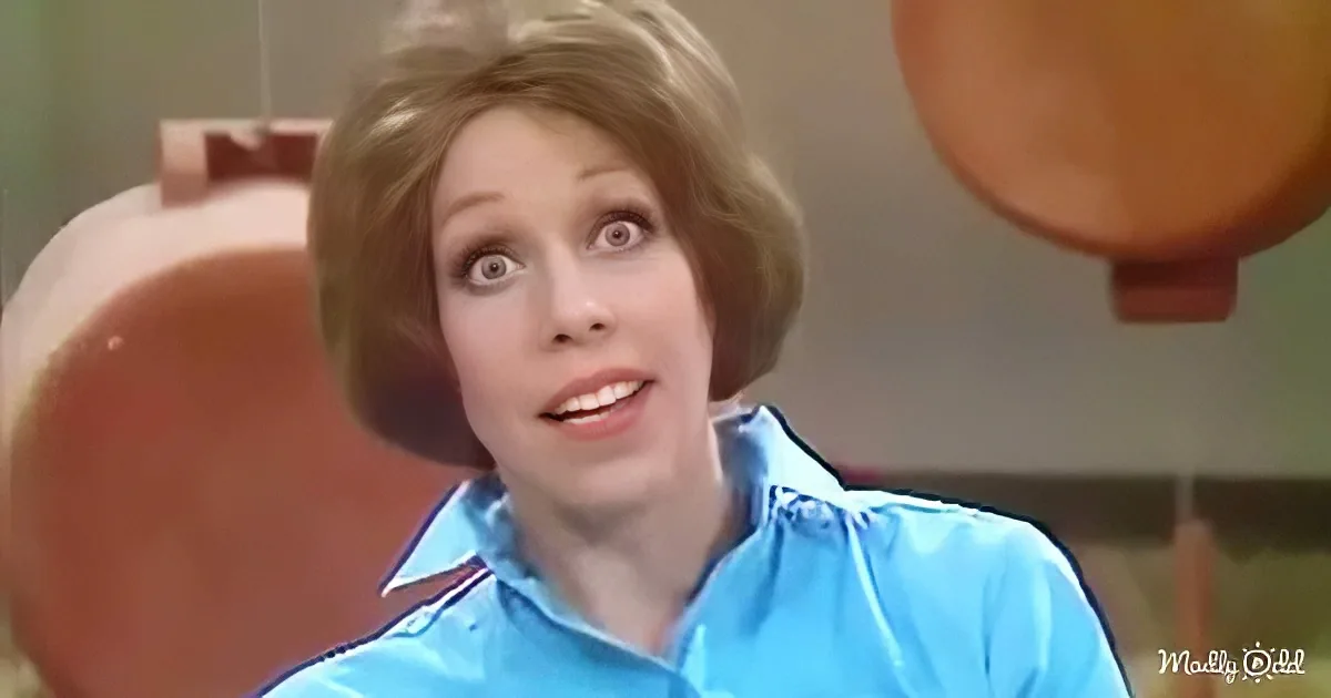 A person with short, light brown hair and a blue shirt appears surprised or shocked.