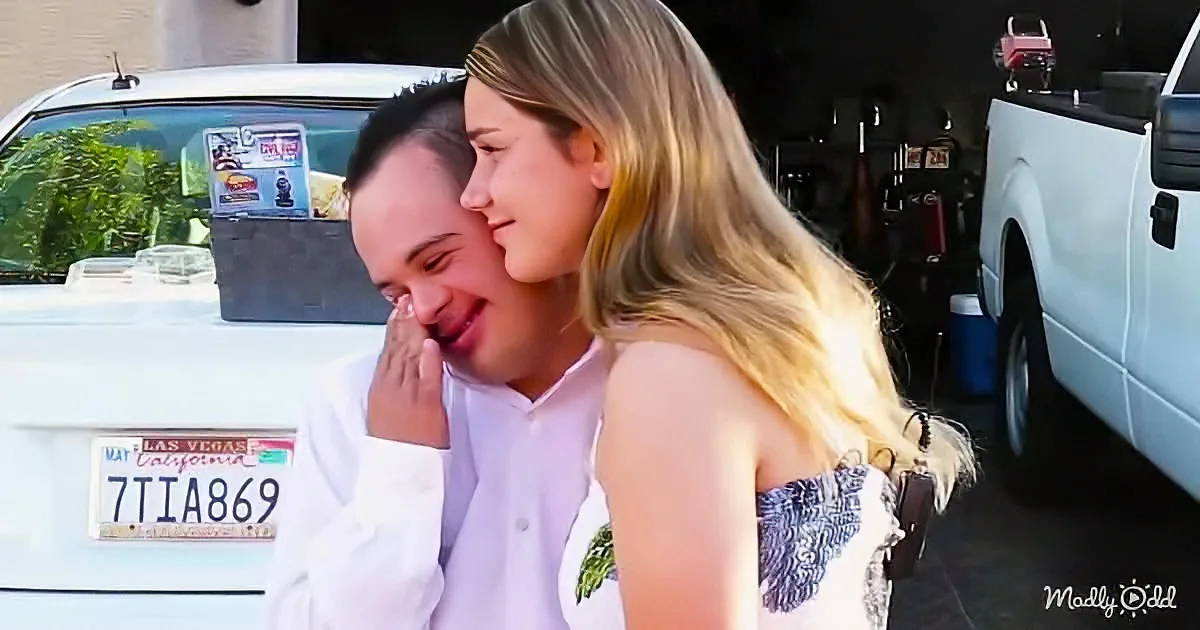 A woman embraces a man, both smiling, with a white truck and Las Vegas license plate in the background.
