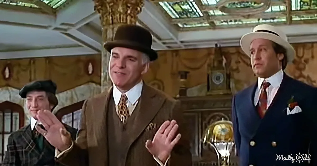 A man in a brown suit and bowler hat gestures animatedly in a luxurious room.