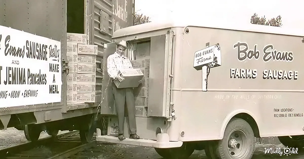 A man stands beside a Bob Evans Farms truck, holding a box of Jemima Pancakes.
