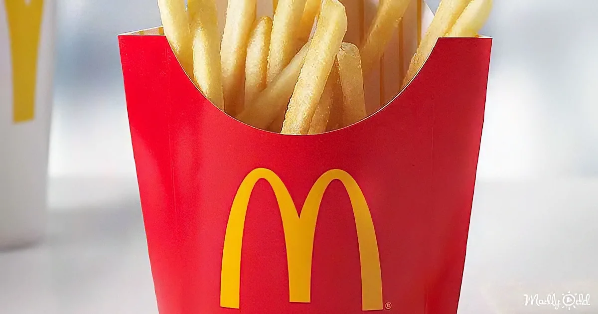 A red McDonald's french fries container with golden fries inside.