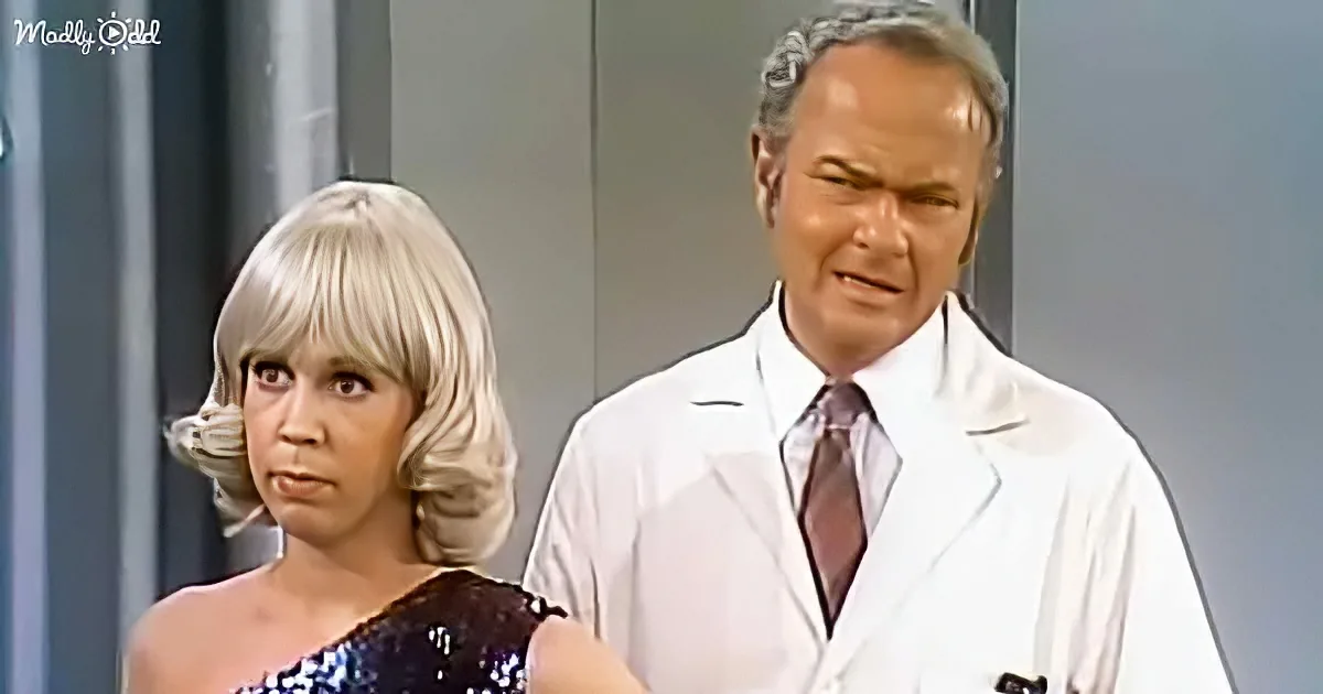 A woman in a sequined dress and a man in a white lab coat stand side by side, both looking concerned.