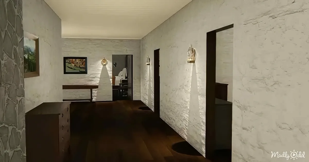 A modern hallway with white textured walls, dark wood floor, and framed artwork.