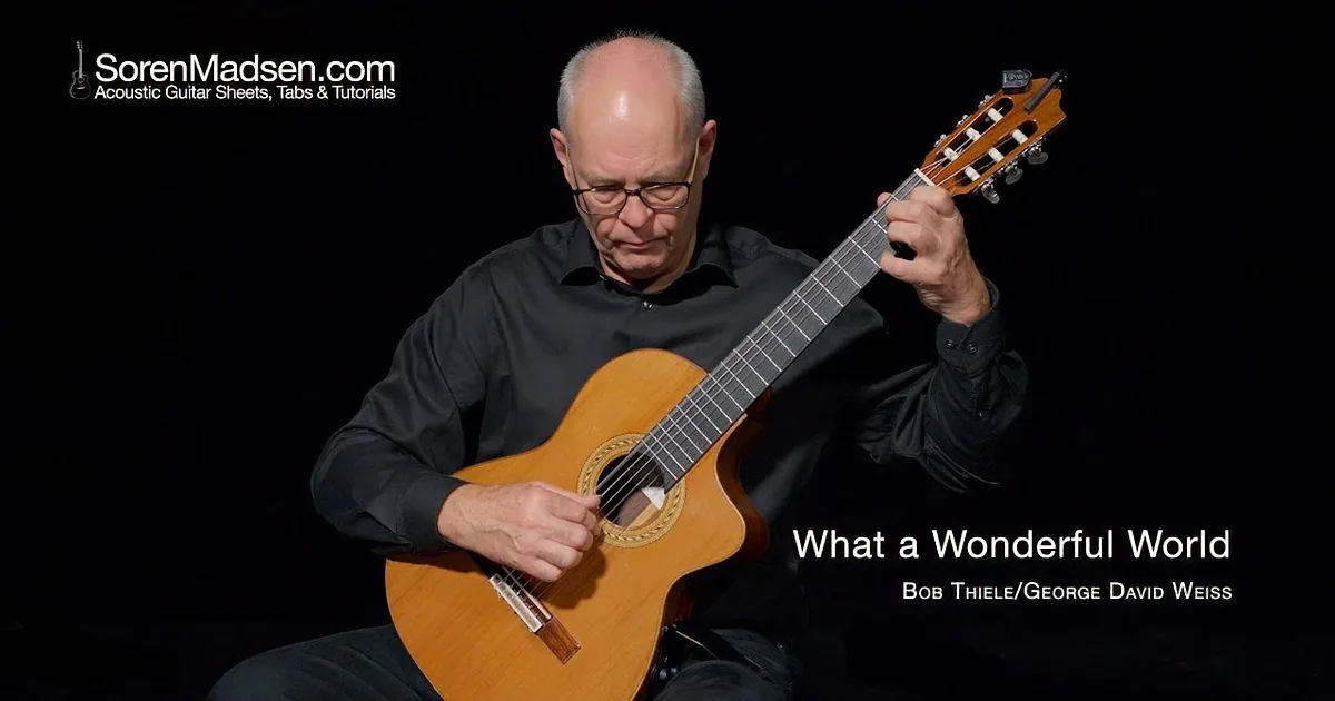 A man in a black shirt plays a classical guitar against a dark background.