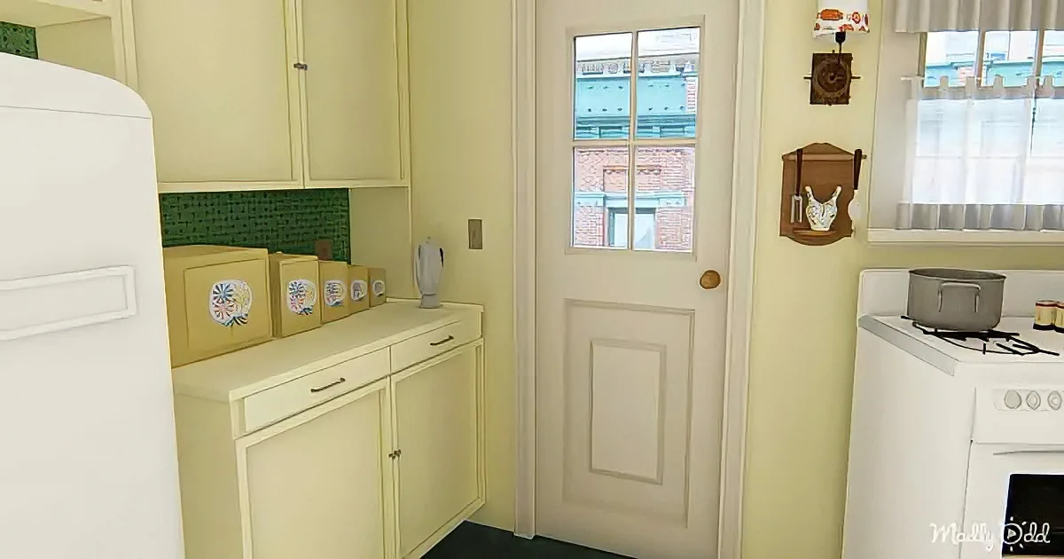 A vintage kitchen with white cabinets, a door, and a stove with a pot on it.