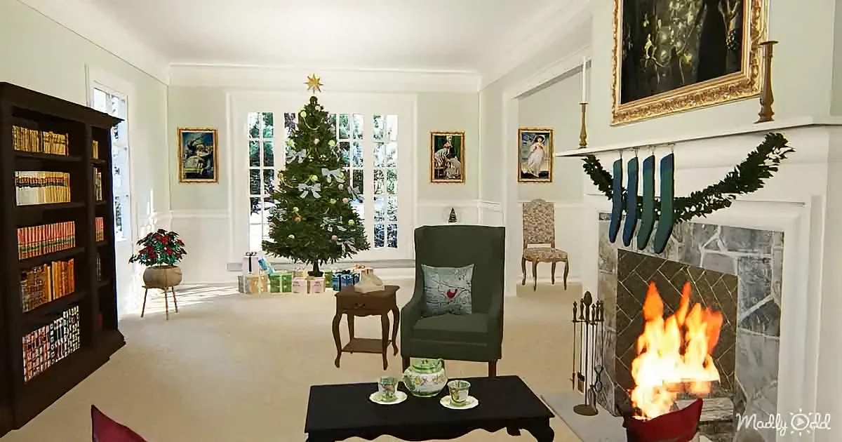 A cozy living room with a Christmas tree, fireplace, and bookshelf, decorated for the holiday season.