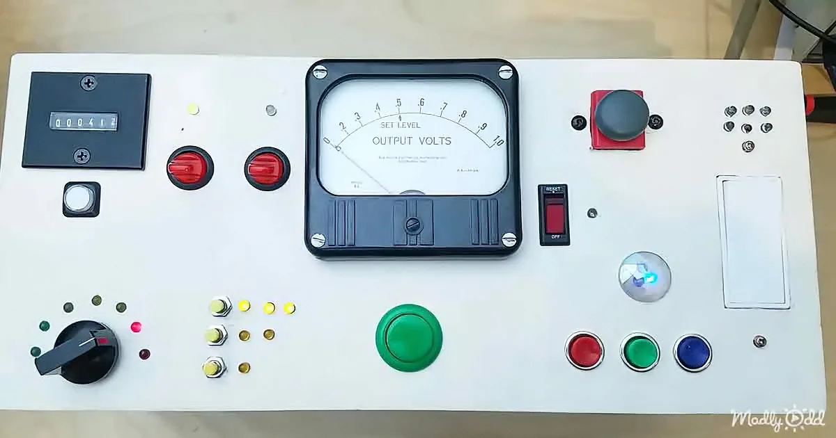 A control panel with a voltmeter, buttons, switches, and a digital display showing "000412".