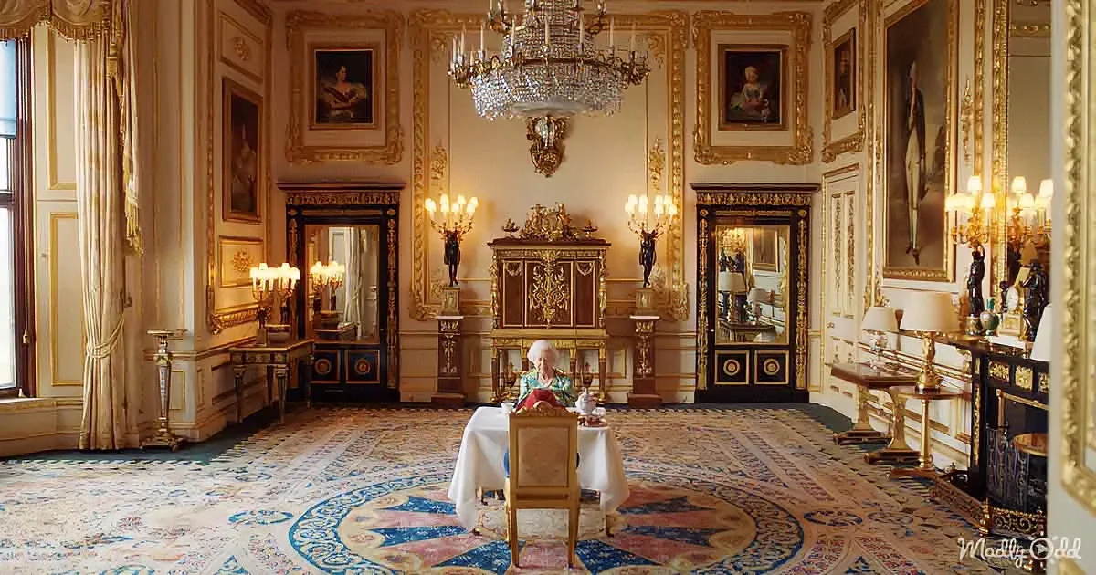A woman sits at a table in an opulent, ornately decorated room with gold accents and paintings.