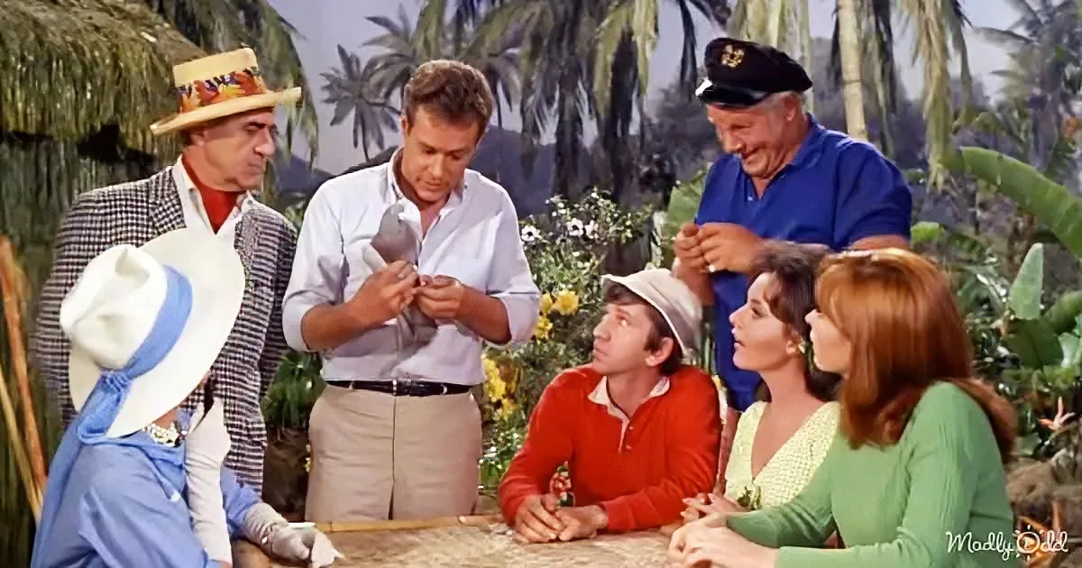A man in a white shirt is holding a bird, surrounded by a group of people in a tropical setting.