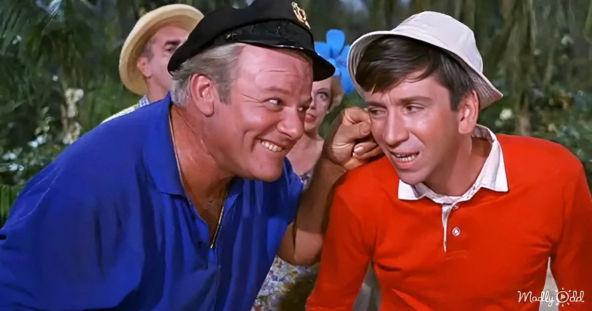 Two men in hats and colorful shirts are interacting closely, with one whispering into the other's ear.