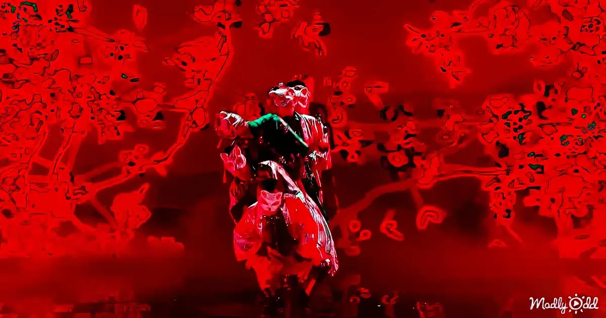 A performer in traditional attire dances against a vibrant red, abstract background.