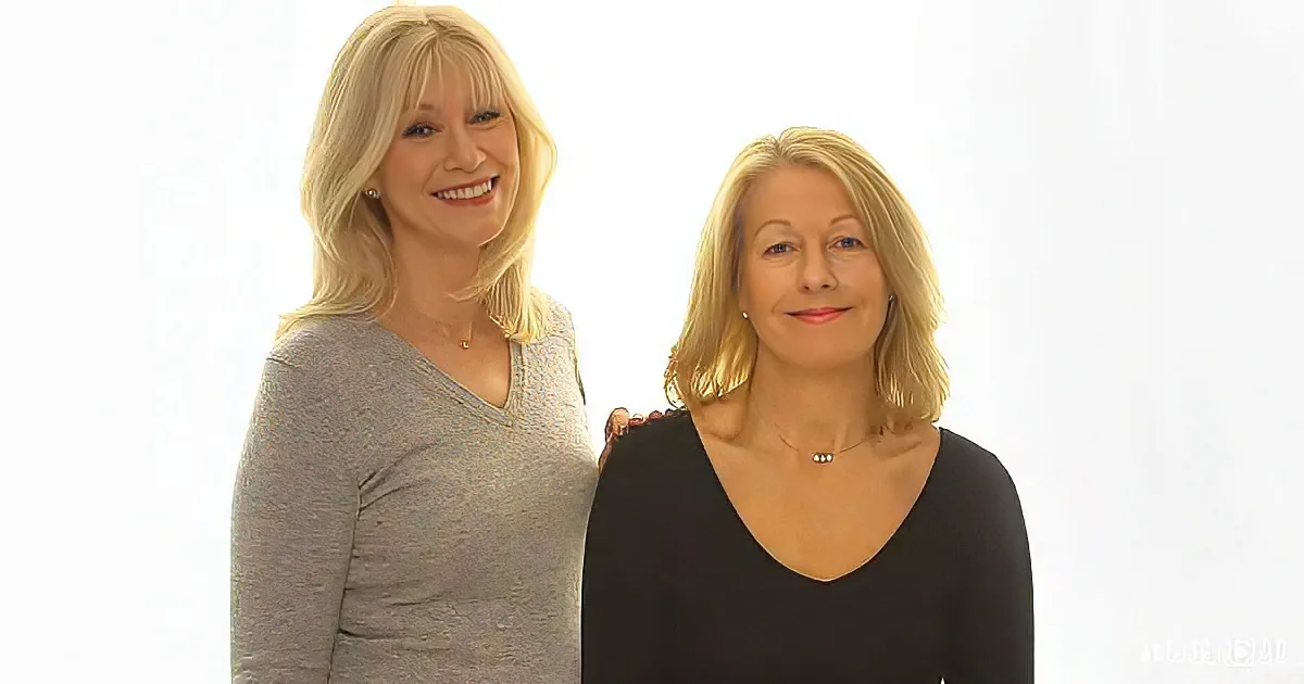 Two women with blonde hair, one in gray, the other in black, standing close together against a white background.