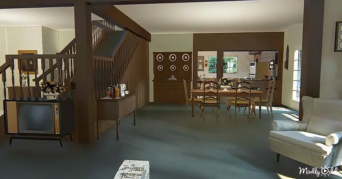 A vintage living room with a TV, staircase, dining table, and floral decor.
