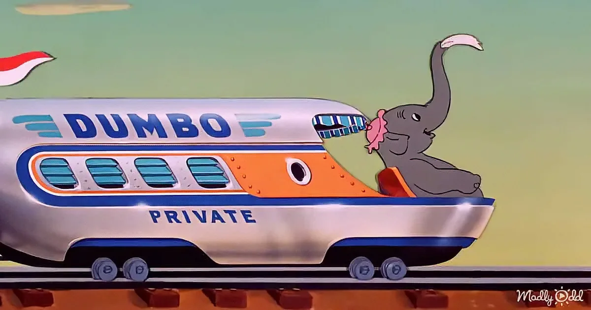 An elephant rides a train labeled "Dumbo Private" with a colorful design.