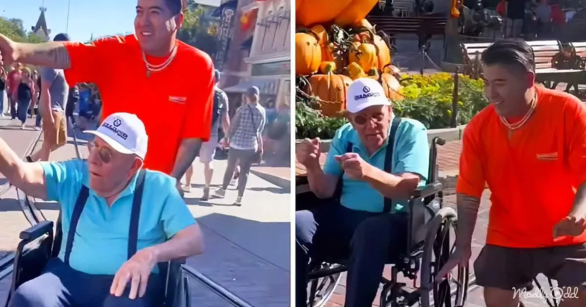 A man in a wheelchair interacts with another man in an orange shirt, surrounded by pumpkins and people at a sunny outdoor...