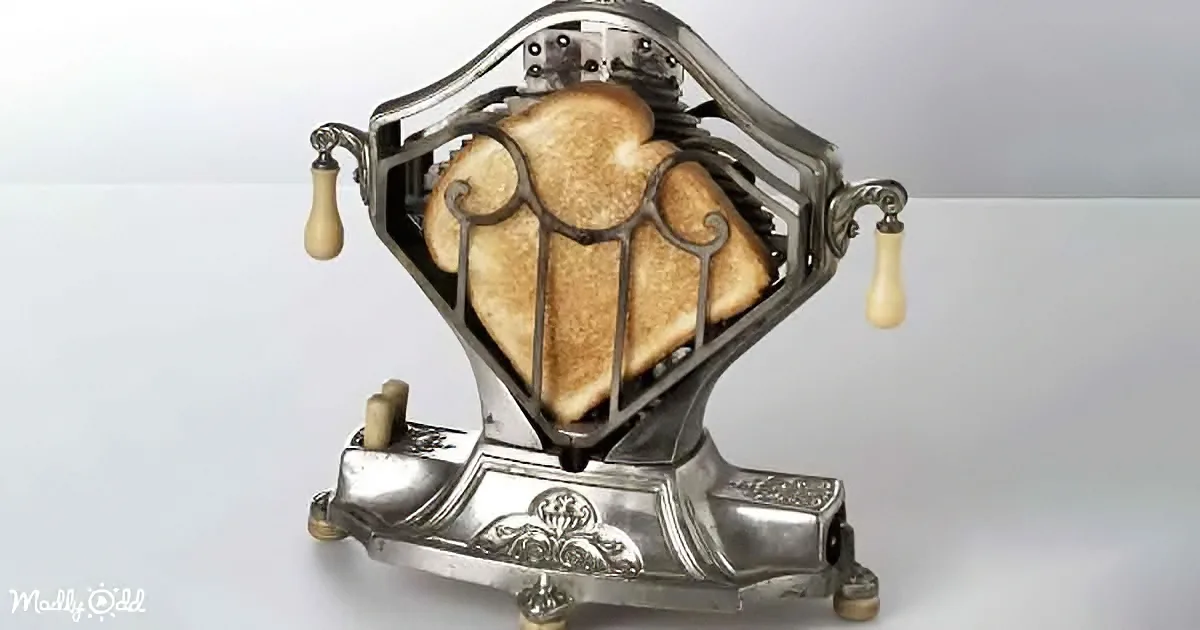 A vintage-style toaster with ornate metalwork and two slices of toasted bread.