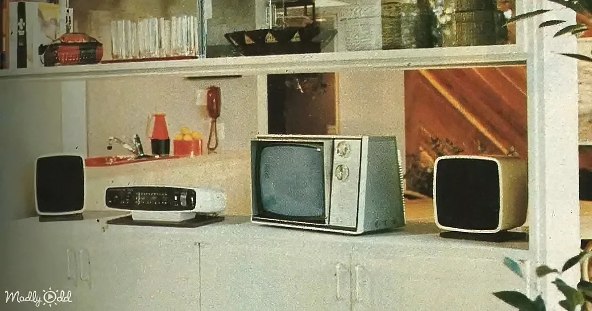 An old-fashioned television set with speakers and a radio on a shelf, surrounded by vintage decor and items.