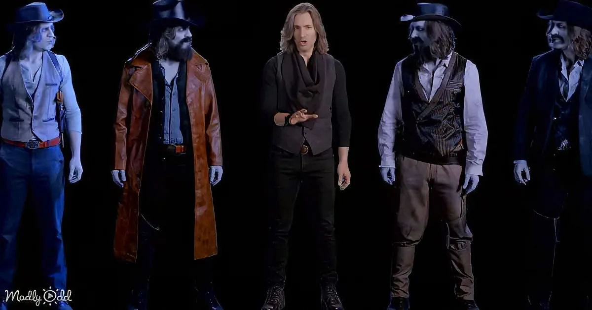 A man in a black outfit stands center, flanked by four men in western attire against a dark background.