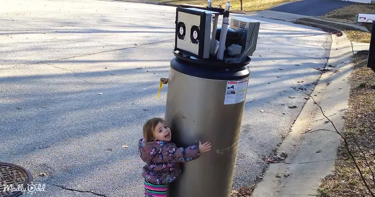 A child hugs a large water heater on a sunny street corner.