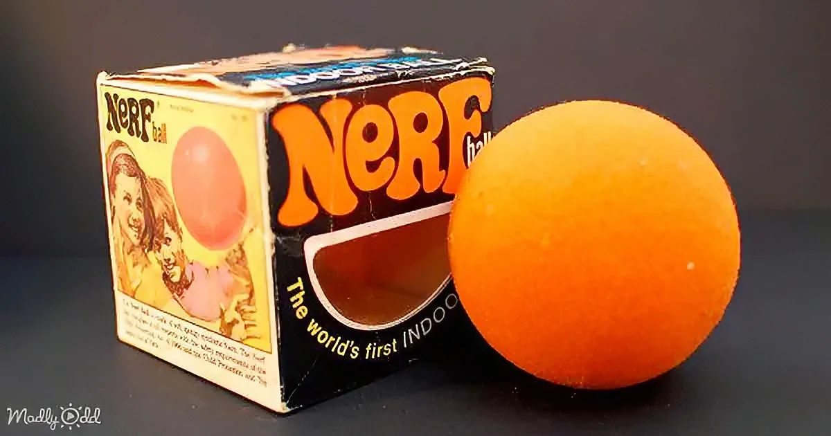 An orange Nerf ball sits beside its vintage box, showcasing the world's first indoor toy.
