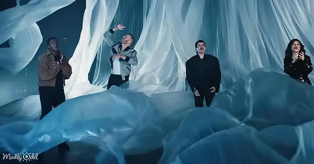 A group of four people stands amidst a surreal, icy landscape with flowing fabric and blue hues.