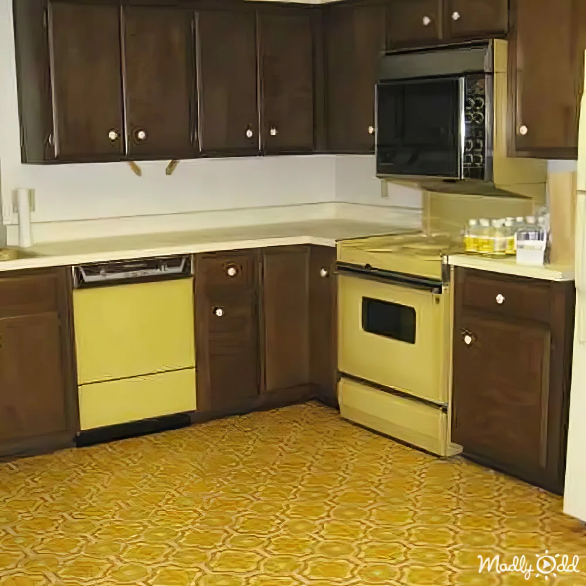 A retro kitchen with dark brown cabinets, yellow countertops, and a patterned yellow floor.