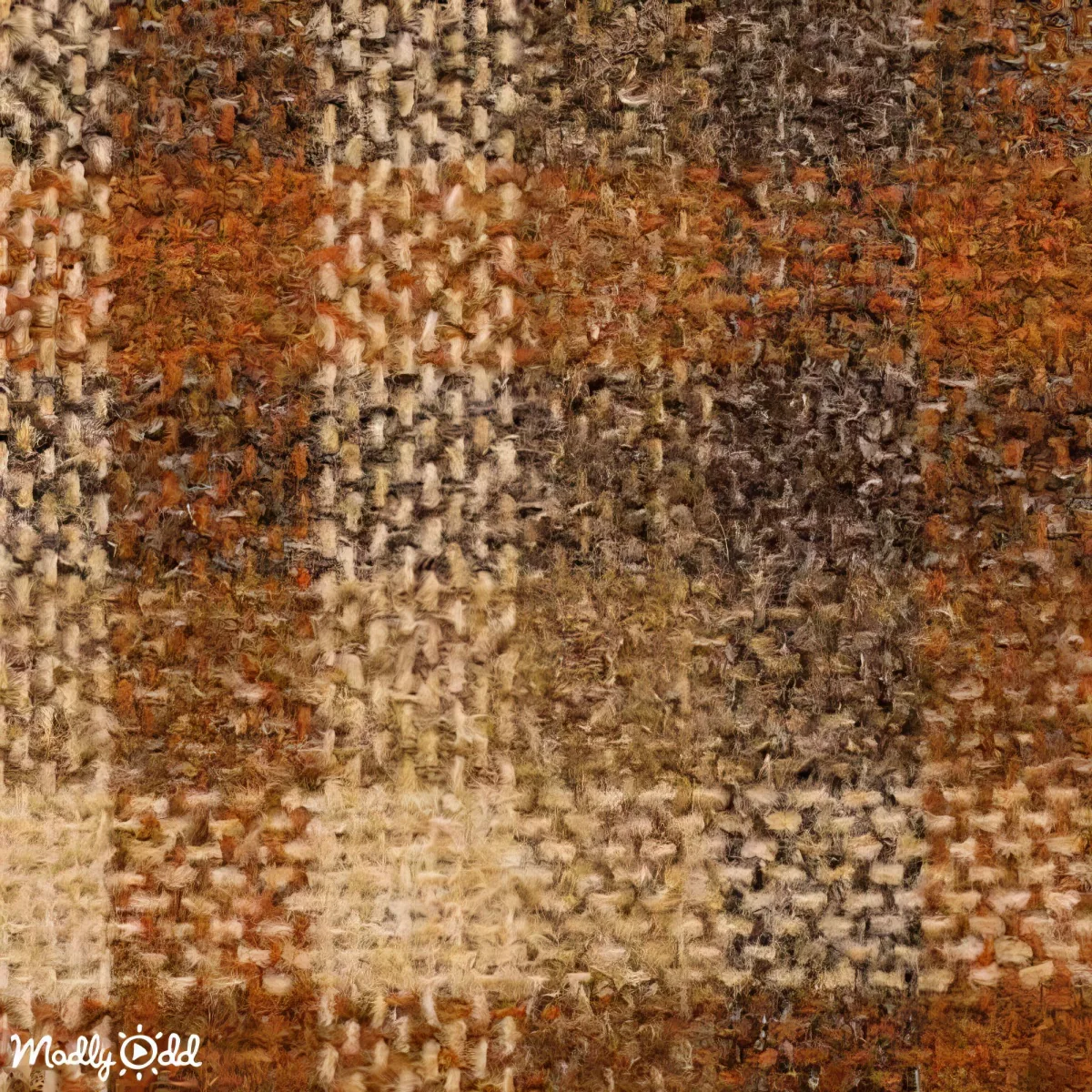 A close-up of a textured fabric with a checkered pattern in shades of brown, beige, and orange.