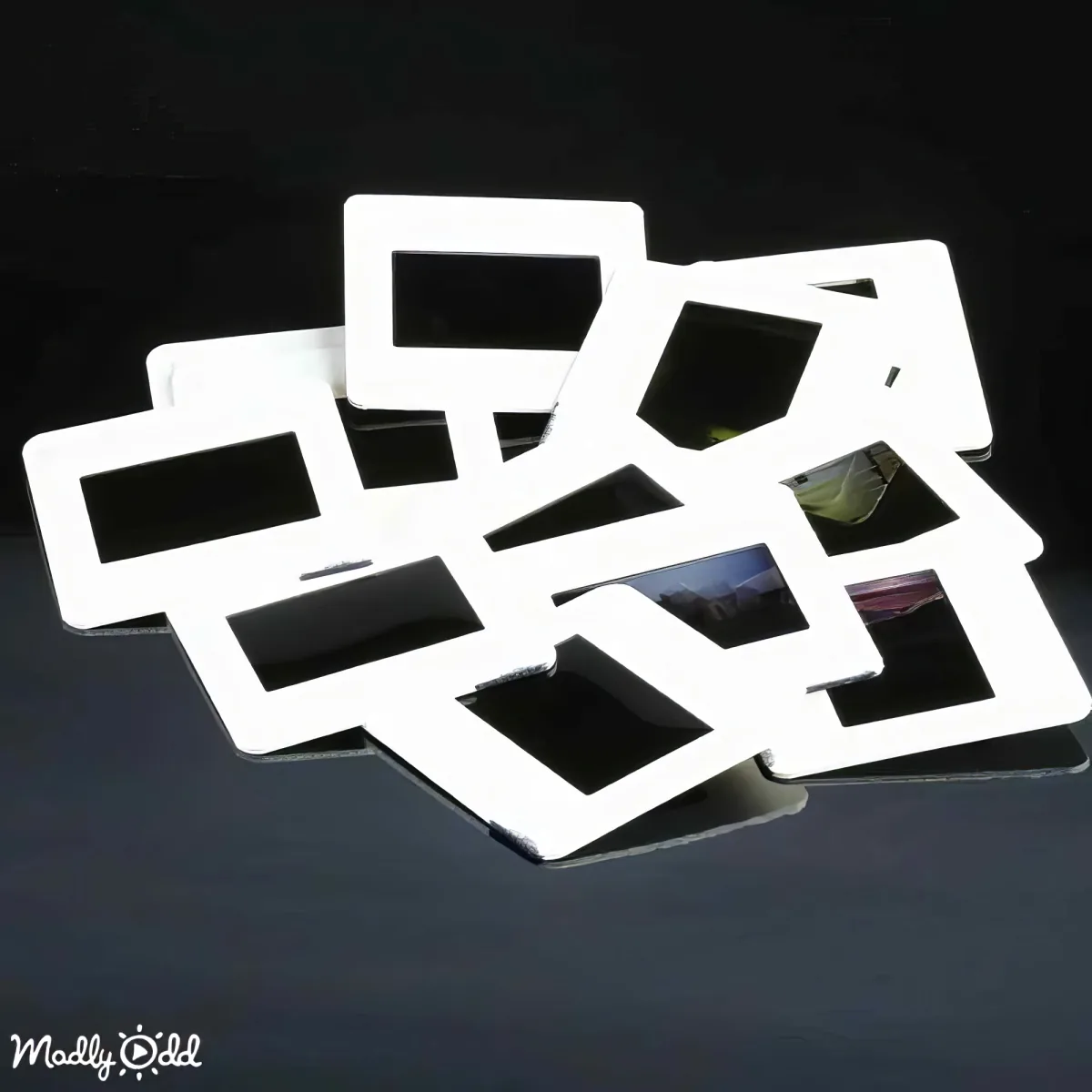 A white, geometric, multi-layered structure resembling a house or abstract art piece is displayed against a black background.
