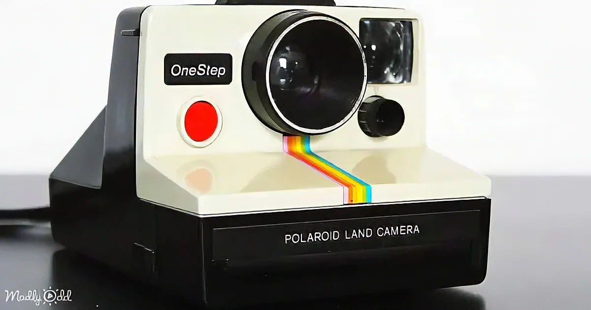 A vintage Polaroid Land Camera with a rainbow-colored light beam exiting the lens.