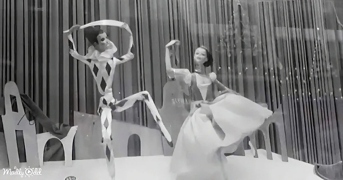 A ballerina in a white dress dances gracefully, accompanied by a skeleton in a jester outfit.