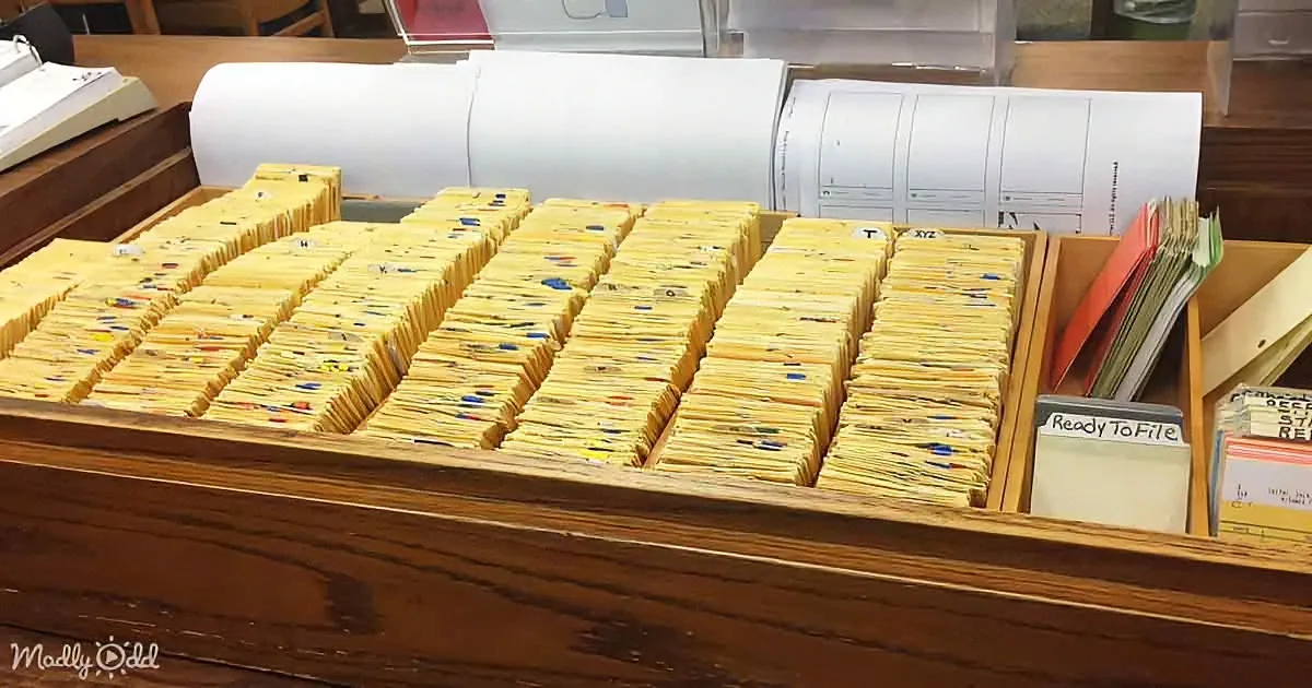 A wooden desk holds neatly organized yellow file folders in a grid, with a "Ready To File" label nearby.